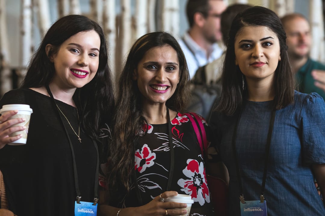 Three female attendees enjoy a coffee break during the 2018 Global Leadership Summit.